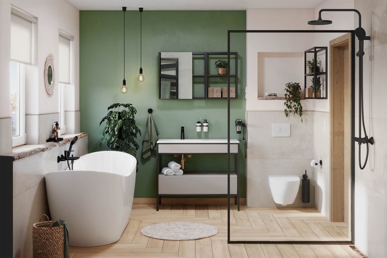 Badezimmer mit freistehender Badewanne, Waschtisch, Dusche und Toilette in heller und freundlicher Atmosphäre