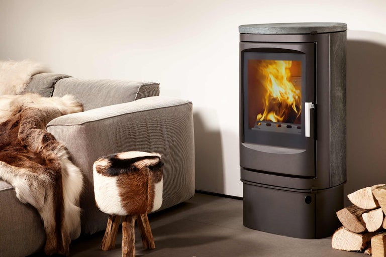 Szene mit Kaminofen, Sofa und Hocker im Wohnzimmer