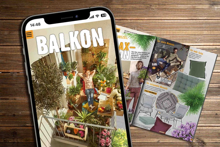 Smartphone zeigt eine Hornbach Balkon-Zeitschrift neben einer geöffneten Zeitschrift auf einer Holzoberfläche