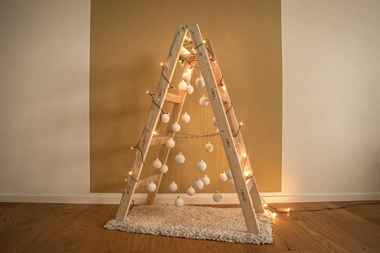 Dekorative Leiter mit Kugeln und Lichterkette als Weihnachtsbaumalternative