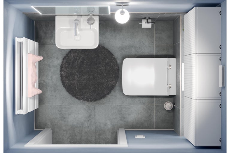 Draufsicht eines Badezimmers mit Waschbecken, Toilette, Heizkörper, Schrank und Badteppich