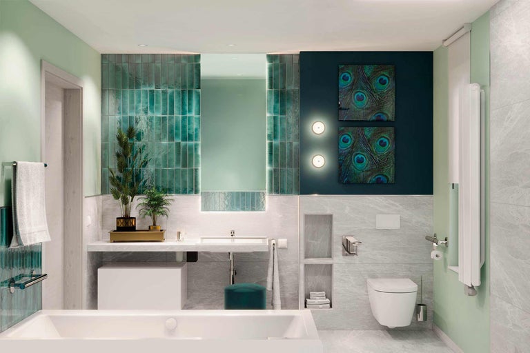 Modernes Badezimmer mit Badewanne, Waschtisch, Toilette und grünen Akzenten
