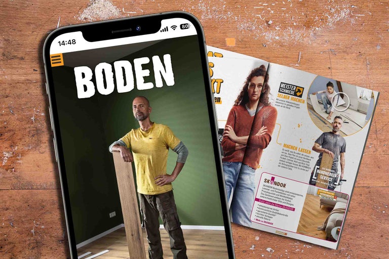 Ein Smartphone zeigt eine Anzeige für Bodenbeläge neben einer Broschüre.