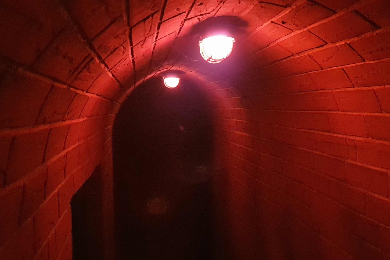 Tunnel aus Ziegelsteinen mit zwei Lampen