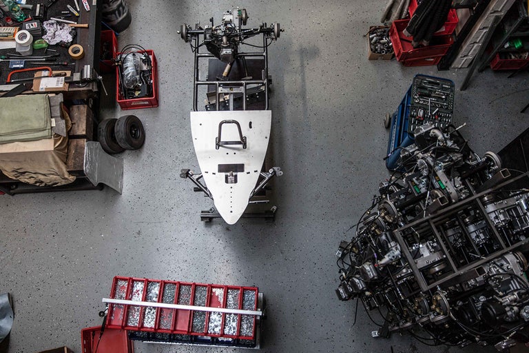 Werkstattansicht von oben mit Kart, Werkzeugen und Autoteilen