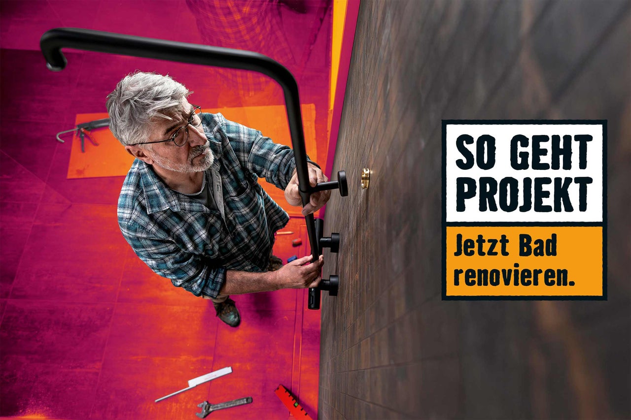 Ein Mann montiert einen Haltegriff im Badezimmer; Text: So geht Projekt. Jetzt Bad renovieren.