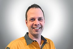Porträt eines lächelnden Mannes in Arbeitskleidung