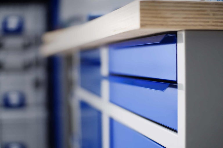 Werkbank mit blauen Schubladen und Holzplatte