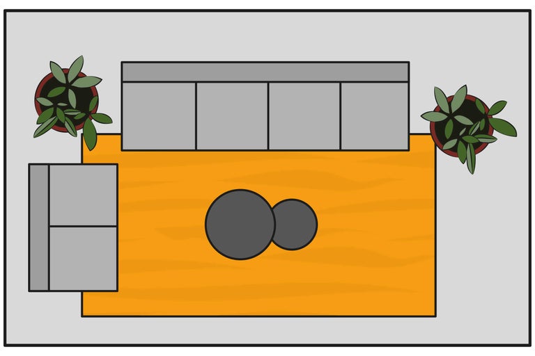 Draufsicht eines Wohnzimmers mit Sofa, Teppich, Couchtisch und Pflanzen