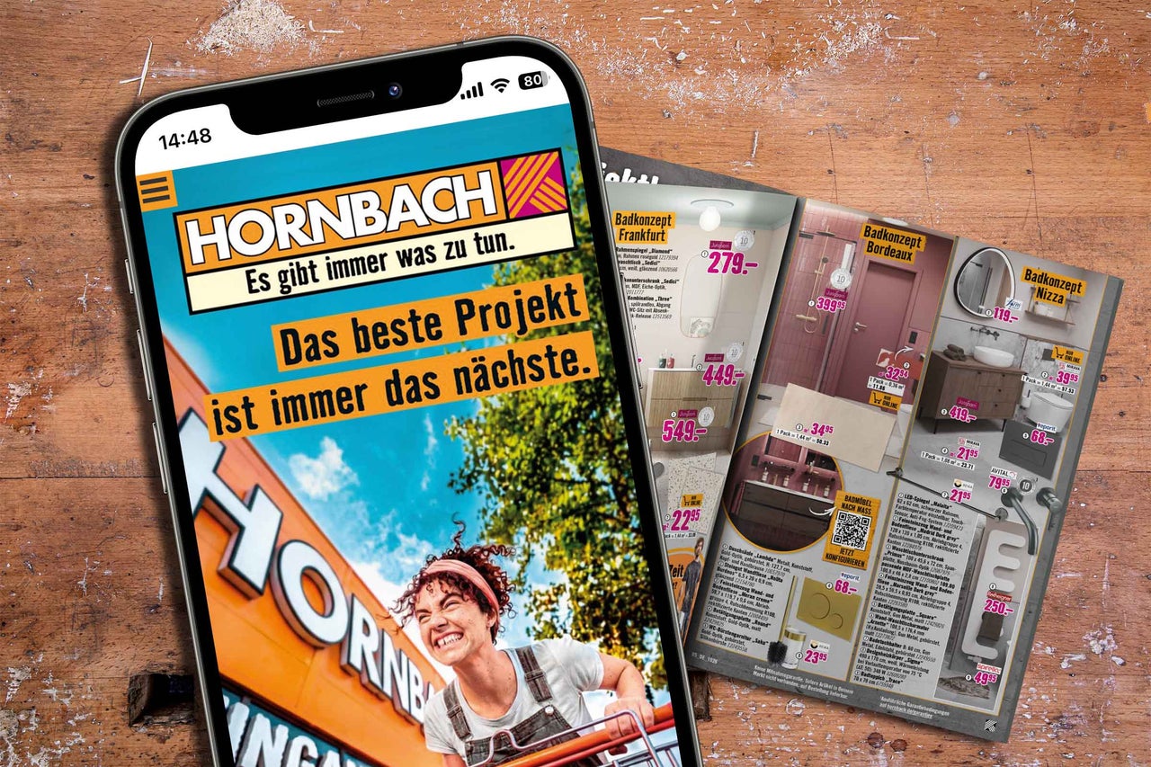 Smartphone zeigt die Webseite des Hornbach Onlineshops mit Badkonzepten und Projektinformationen auf einem Holztisch.