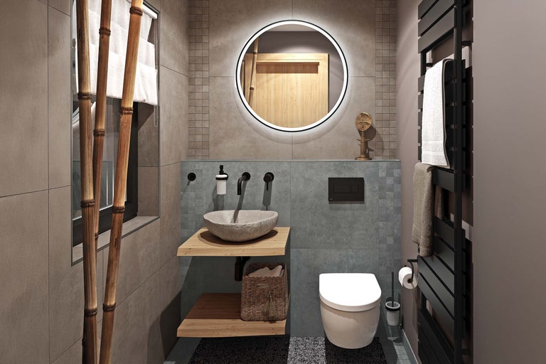 Badezimmer mit Waschtisch, Spiegel, Toilette und Handtuchwärmer.