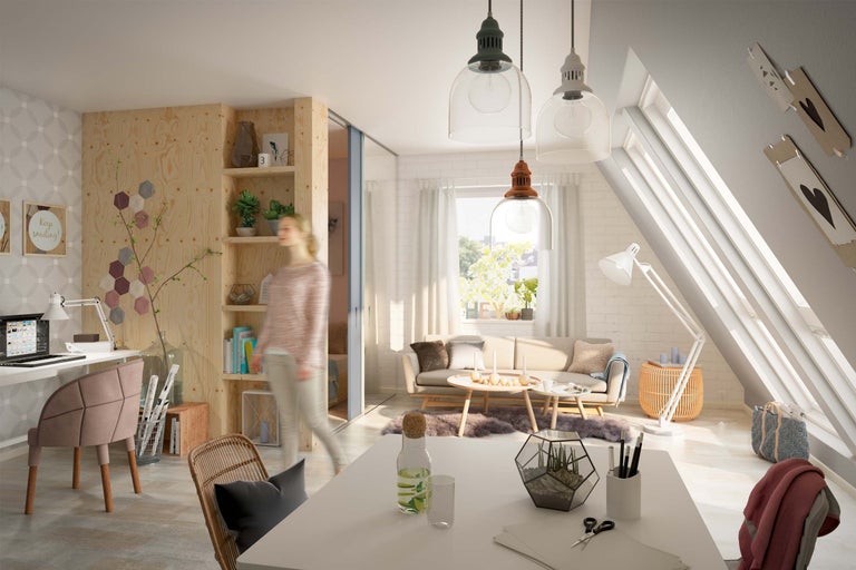 Heller Dachgeschossraum mit Arbeitsbereich, Sitzgruppe und Holzregal