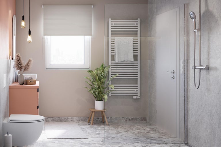 Modernes Badezimmer mit Toilette, Waschtisch, Heizkörper und Duschkabine für ein stilvolles Ambiente