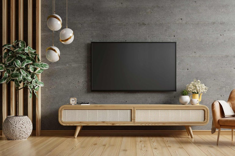 Wohnzimmer mit Fernseher, TV-Möbel, Dekoration und Zimmerpflanzen