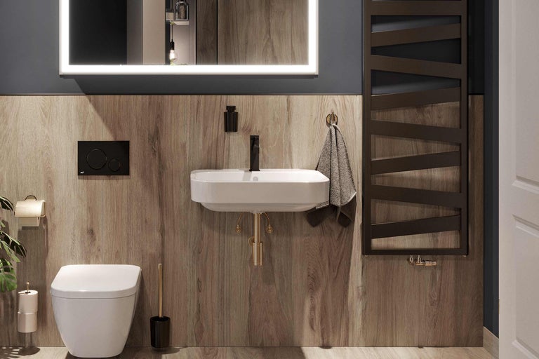 Modernes Badezimmer mit Toilette, Waschtisch, Spiegel mit Beleuchtung und Heizkörper