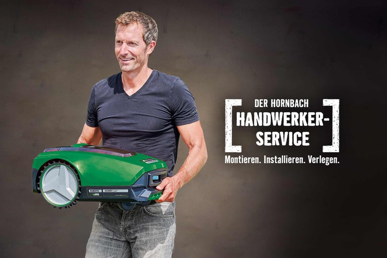 Ein Mann hält einen grünen Mähroboter. Der Hornbach Handwerkerservice bietet Montage, Installation und Verlegung.