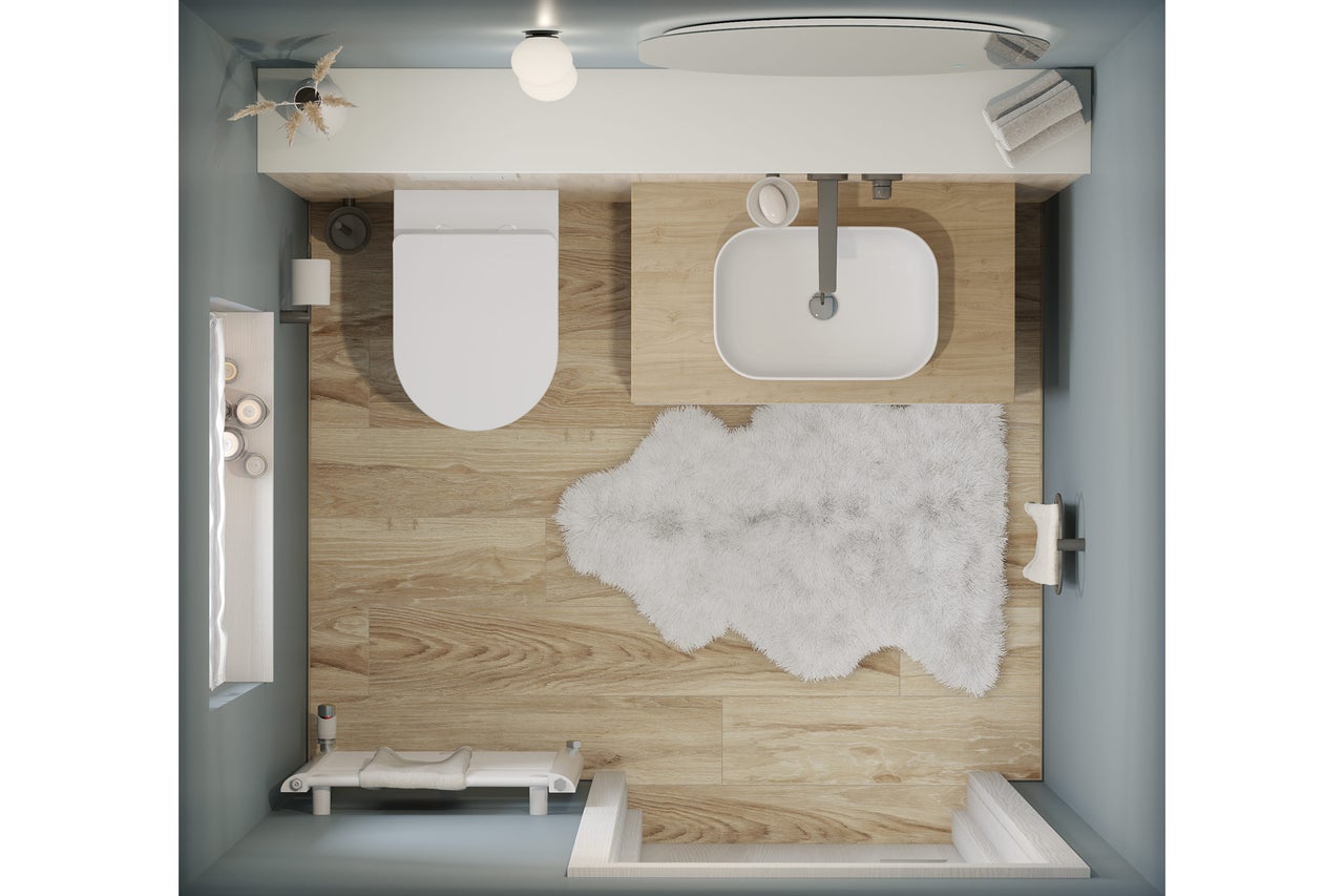 Vogelperspektive eines Badezimmers mit Toilette, Waschbecken, Badewanne und Teppich