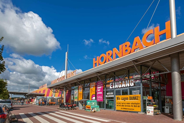 Außenansicht des Hornbach Baumarktes mit Eingangsbereich und Parkplatz.
