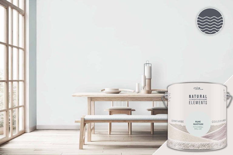 Helle und freundliche Raumszene mit Tisch und Stühlen sowie einem Farbeimer Lehmfarbe