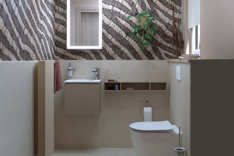 Badezimmer mit Waschbecken, Toilette, beleuchtetem Spiegel und Dekor