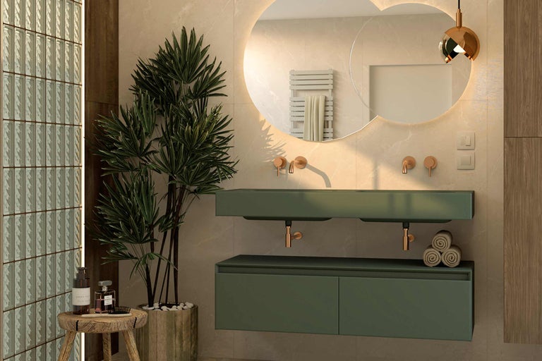 Modernes Badezimmer mit grünen Waschtischen, runden Spiegeln mit Beleuchtung und dekorativen Elementen wie einer Zimmerpflanze und Handtüchern