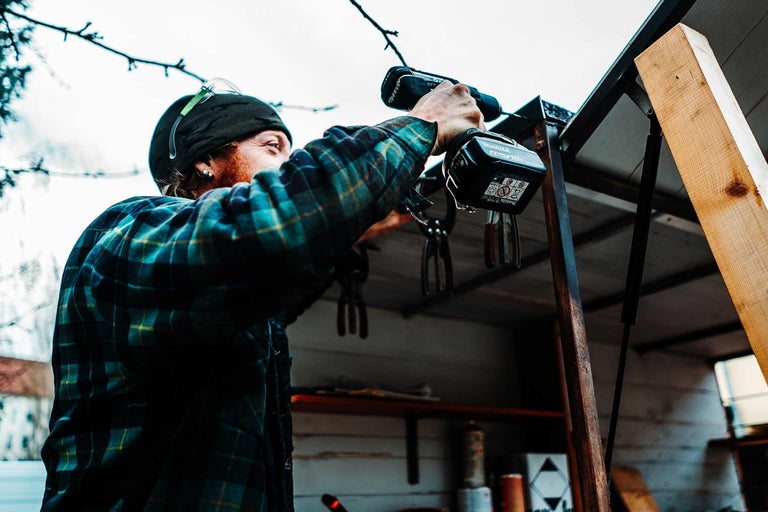 Handwerker arbeitet mit einem Akku-Bohrschrauber an einem Bauprojekt.