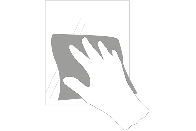 Eine Hand reinigt mit einem Tuch eine Oberfläche.