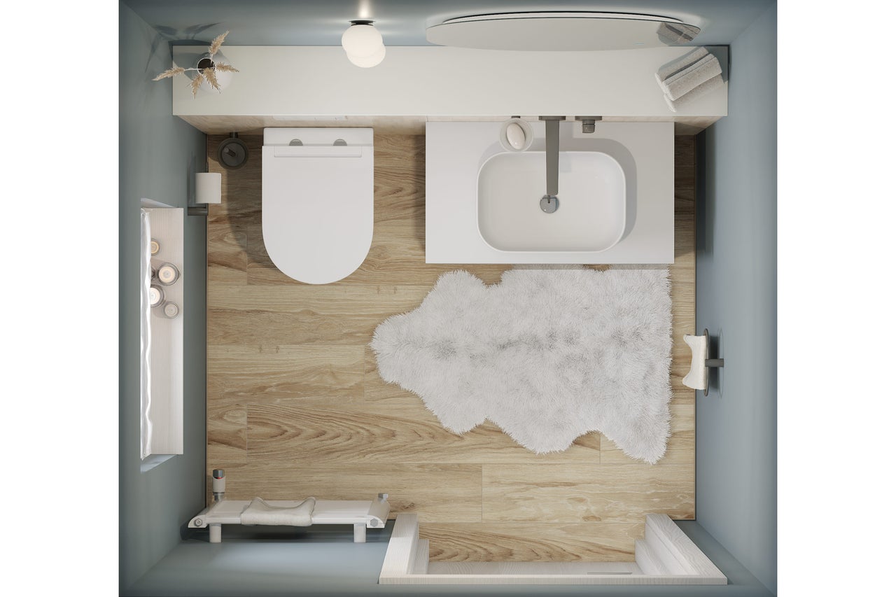 Draufsicht eines Badezimmers mit Toilette, Waschbecken, Badewanne und Badteppich