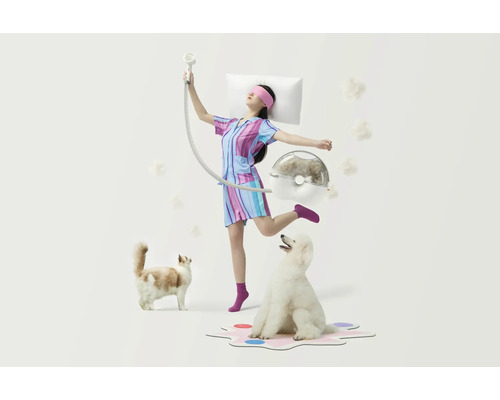 Szene mit einer Frau, die eine Schlafmaske und einen Pyjama trägt, einem Staubsauger für Haustiere hält und von einer Katze und einem Hund umgeben ist.