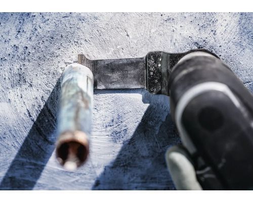 Oszillierendes Elektrowerkzeug mit Metallsägeblatt beim Schneiden eines Metallrohrs.