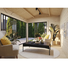 Helle Holzhütte mit Sesseln, Couchtisch und großen Fenstern für Gartenblick