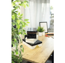 Stapel von drei dekorativen Schachteln auf einem Tisch