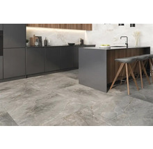 Moderne Küche mit Kücheninsel, Barhockern und Bodenfliesen in Steinoptik.