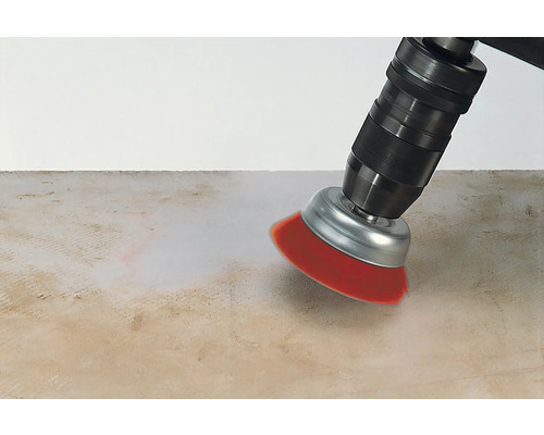 Eine Bohrmaschine mit Bürstenaufsatz reinigt eine Oberfläche.