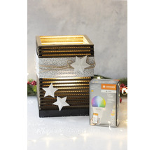 LEDVANCE Lampe in Verpackung neben einer dekorativen Laterne.