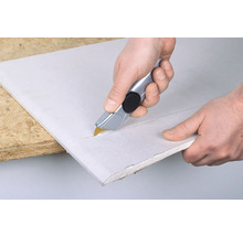 Zuschneiden einer Gipskartonplatte mit einem Cutter.