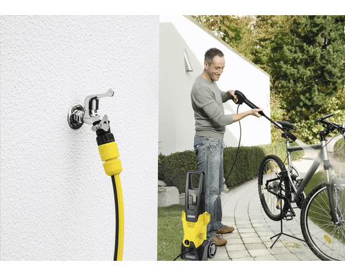 Ein Mann reinigt ein Fahrrad mit einem Hochdruckreiniger von Kärcher. Zu sehen ist auch ein Wasserhahn mit Schlauchanschluss.