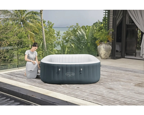 Aufblasbarer Lay-Z-Spa Whirlpool mit Frau im Garten auf der Holzterrasse.