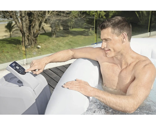 Mann bedient ein aufblasbares Whirlpool-Kontrollpanel im Freien