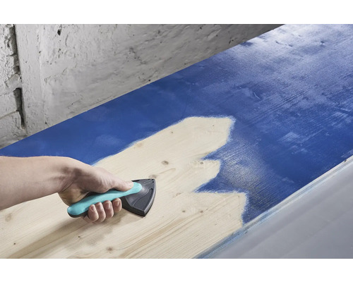 Eine Person verwendet einen Farbverteiler zum Auftragen von Farbe auf Holz