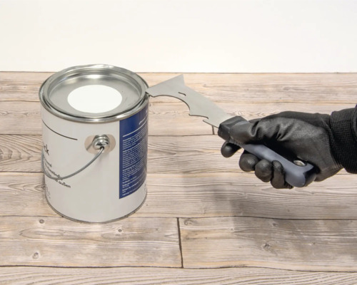 Farbdose wird mit einem Werkzeug geöffnet