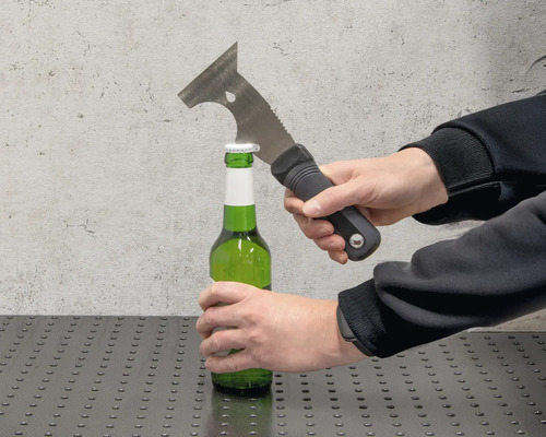 Eine Person öffnet eine grüne Flasche mit einem Multifunktionswerkzeug.
