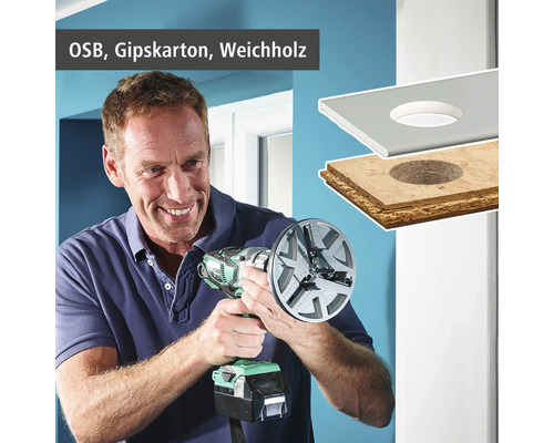 Mann bohrt mit einem Lochschneider ein Loch in eine OSB Platte, eine Gipskartonplatte und Weichholz