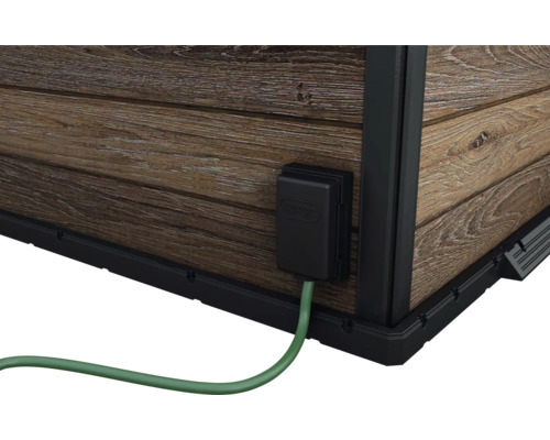 Detailansicht eines Gartenhauses mit Stromanschluss und Holzwand