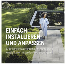 Eine Frau geht in einem Garten mit Teich auf einem Steinweg.