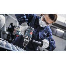 Eine Person bohrt mit einer Akku-Bohrmaschine in ein Material.