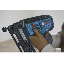 Bosch Professional Akku-Nagler wird von einer Hand in einem Arbeitshandschuh bedient.