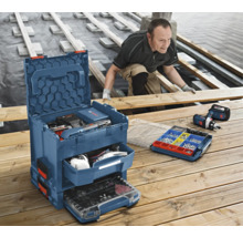 Handwerker arbeitet an Holzterrasse mit Bosch L-BOXX Werkzeugkoffersystem inklusive Schubladen und Kleinteilemagazin.