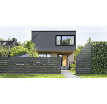 Modernes Haus mit Holz- und Paneelfassade, davor ein Metallzaun mit horizontalen Aussparungen, Gartenweg und Hecke.