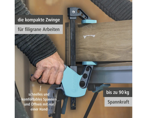 Wolfcraft Einhandzwinge fixiert Holzbrett auf Werkbank, Einhandbedienung mit bis zu 90 Kilogramm Spannkraft.